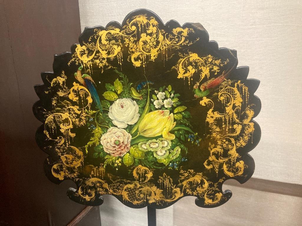 A Victorian ebonised pole screen with papier mache banner, height 130cm